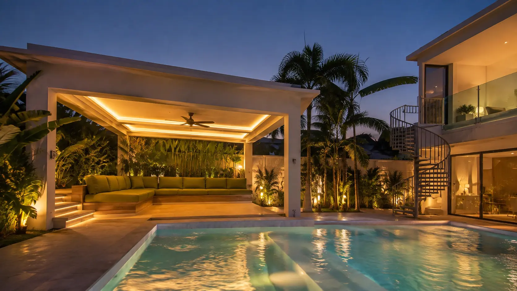 The illuminated outdoor lounge and pool at Sun House Rawai after sunset