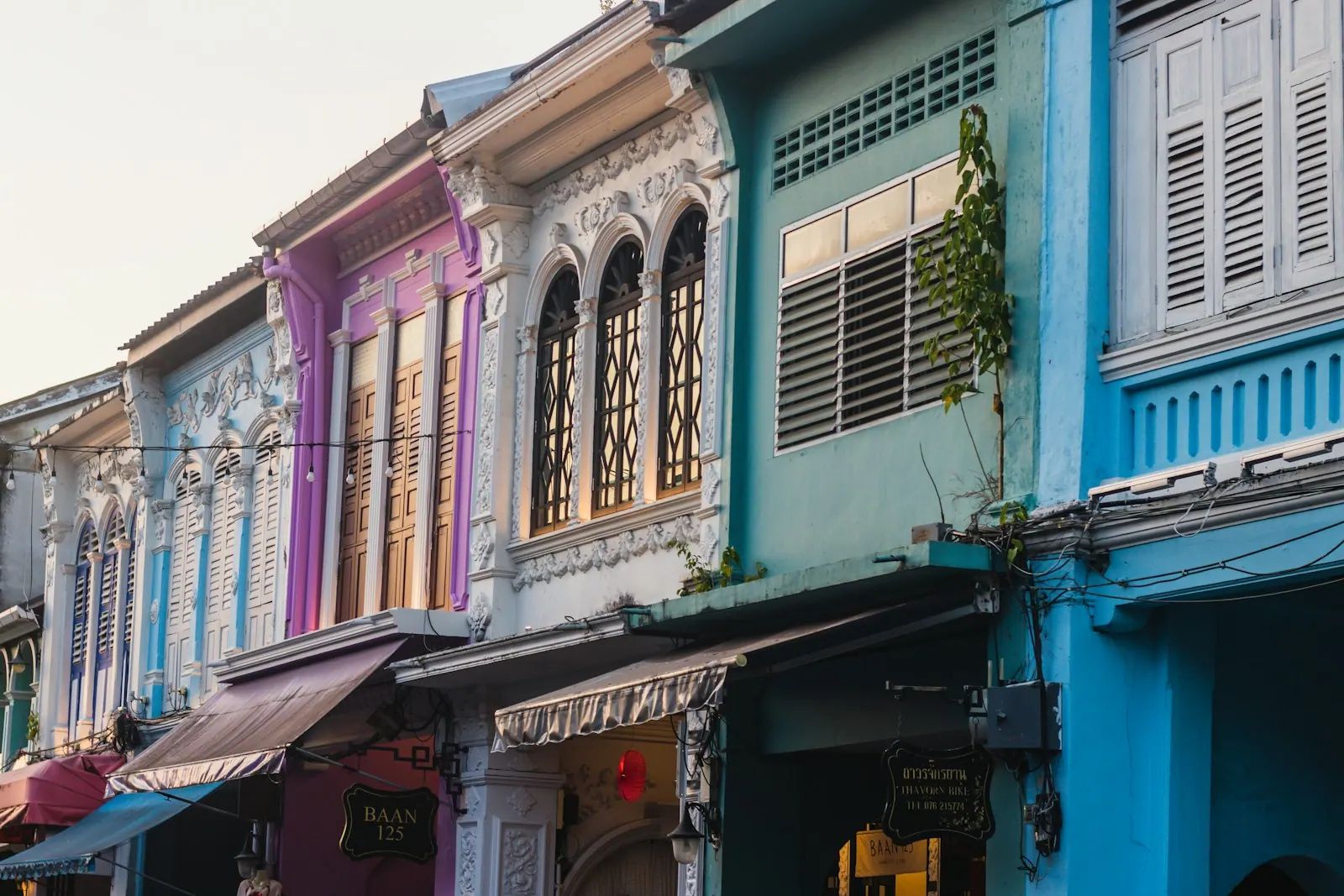 Pastel Sino-Portuguese shophouse facades along a street in Old Phuket Town