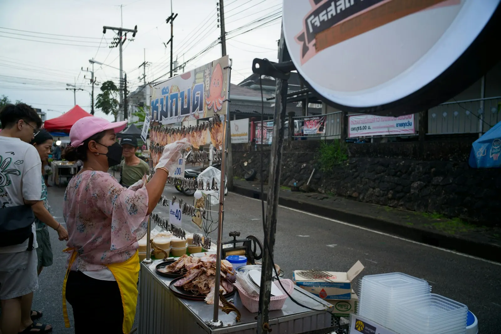 Shoppers choosing from the trays at an open-air seafood market